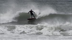 Kaira Wallace surfing