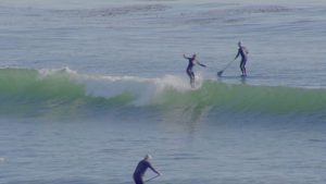 Kaira Wallace surfing with friends